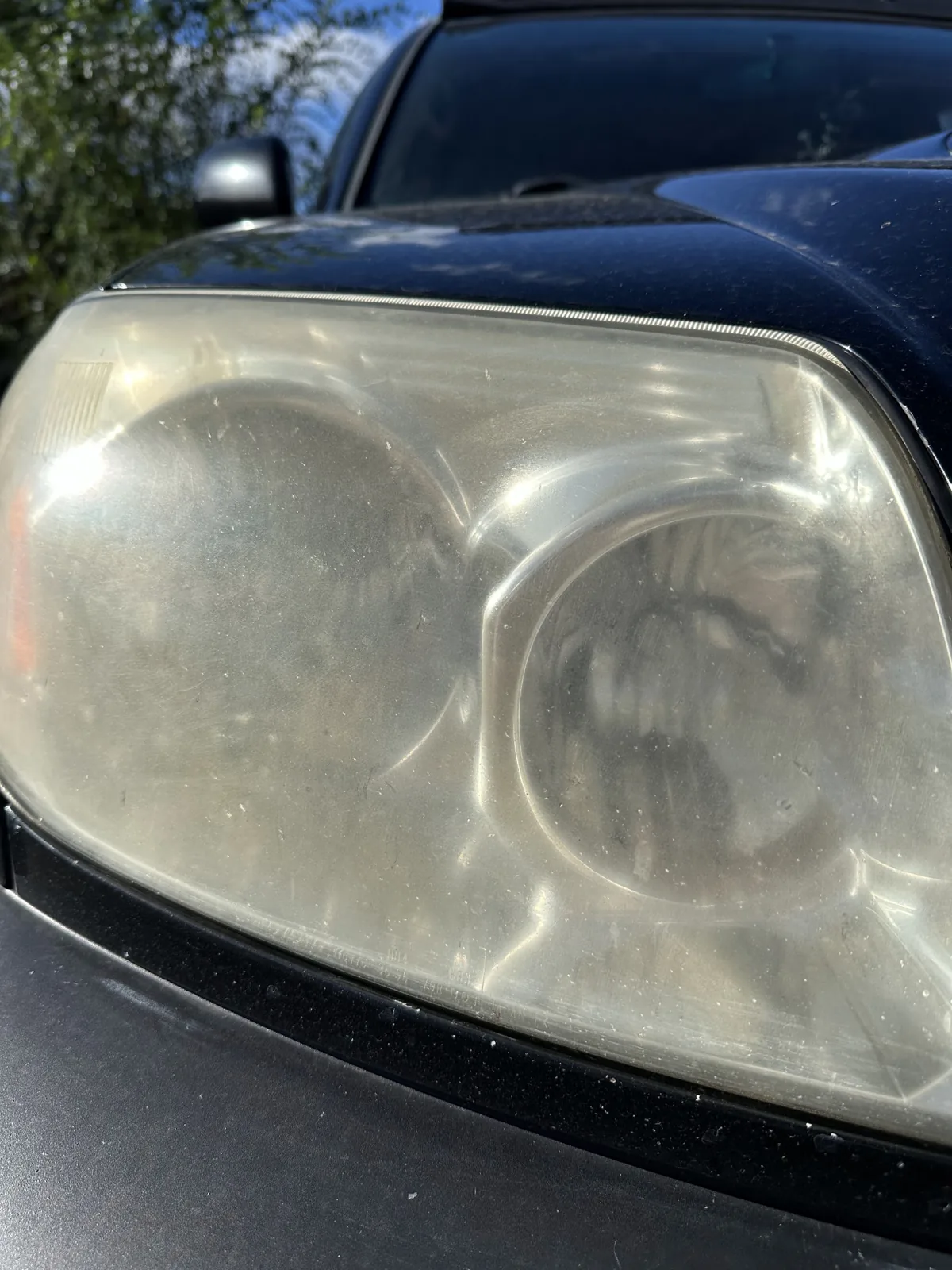 Before: oxidized, yellowed headlight lens on a Kelowna vehicle