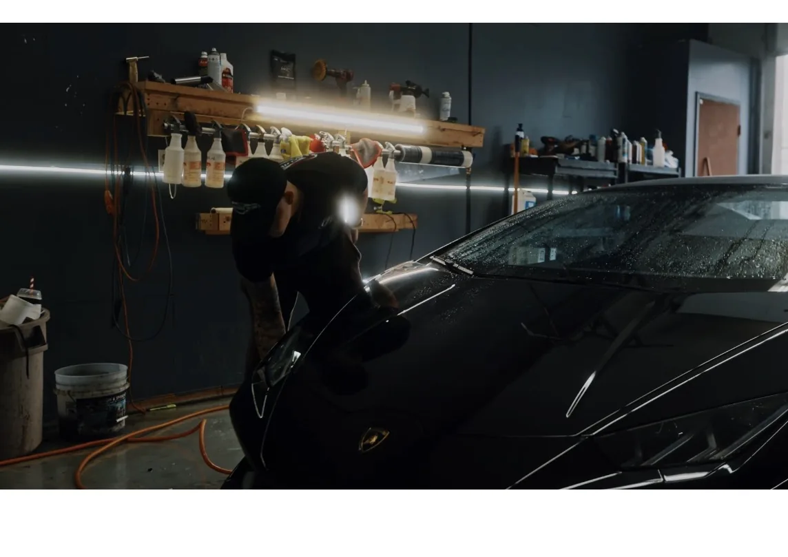 Paint correction on a black car under inspection lights at Kelowna Details