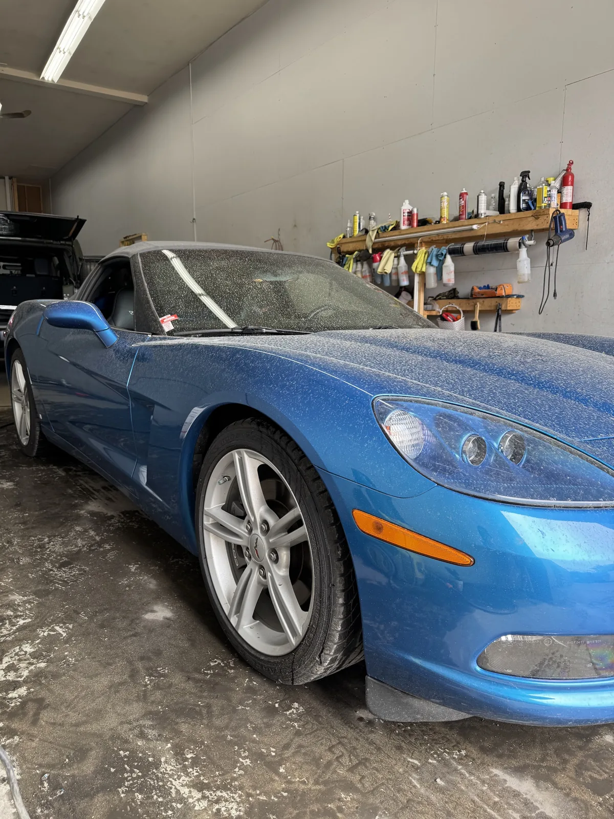 Blue Corvette being washed and decontaminated in the Kelowna Details wash bay